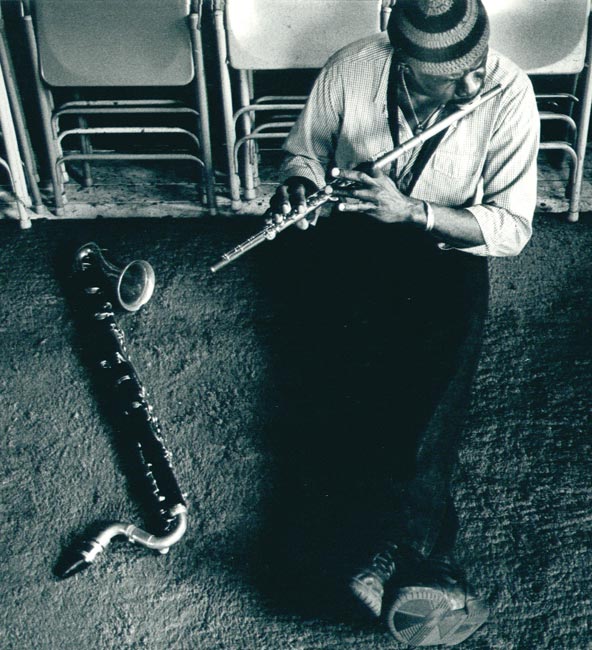 Makanda Ken McIntyre playing the flute in his Studio on West Broadway, NYC, 1980s