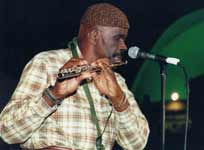 Makanda Ken McIntyre playing the flute, Kwanzaa celebration, Museum of Natural History, NYC, Dec., 2000